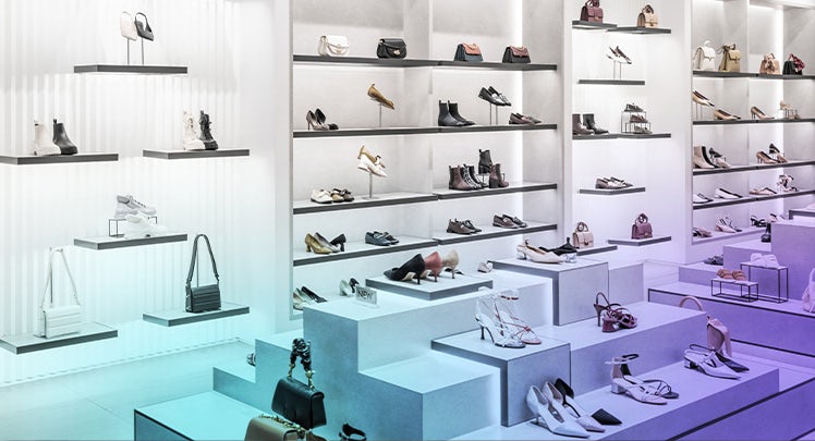 A display of shoes on shelves in a store.
