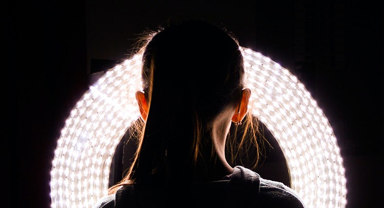 A woman's head in a circle of light.