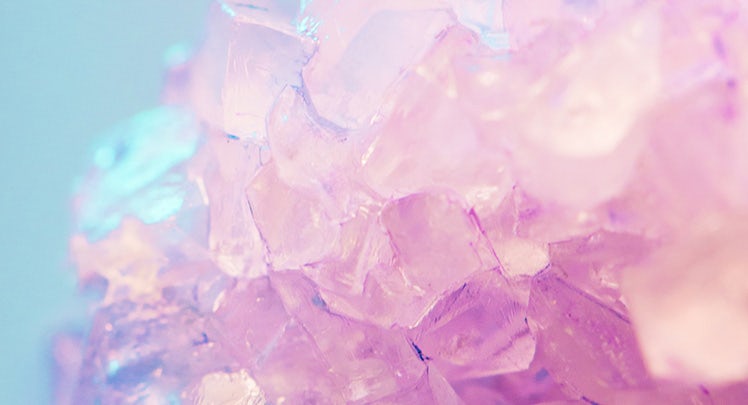 A close up of a pink and purple crystal.
